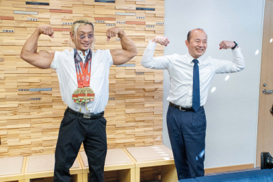 筋肉を見せるポーズをしている中川選手と市長