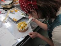 果物の間に生クリームを絞り出している